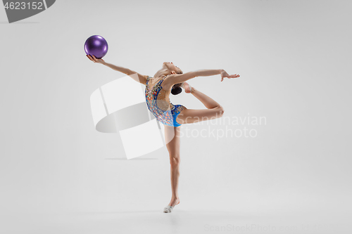 Image of The teenager girl doing gymnastics exercises isolated on white background