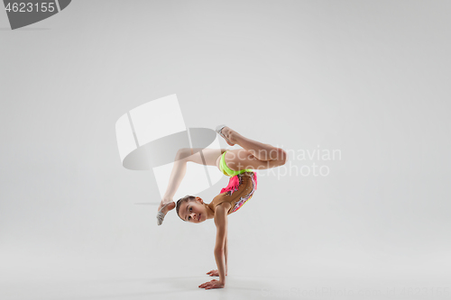 Image of The teenager girl doing gymnastics exercises isolated on white background