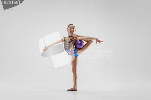 Image of The teenager girl doing gymnastics exercises isolated on white background