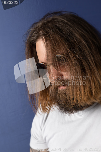 Image of bearded young man with long hair and sunglasses