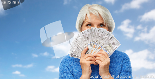 Image of senior woman with hundred dollar money banknotes