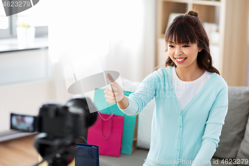 Image of female blogger making video blog about shopping