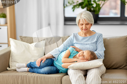 Image of grandmother and granddaughter sleeping on pillow