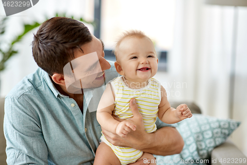 Image of father with little baby daughter at home