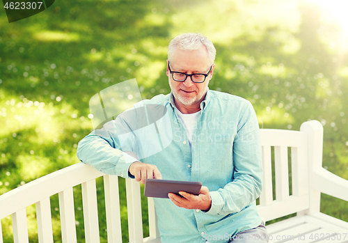 Image of senior man with tablet pc at summer park