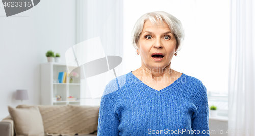 Image of shocked senior woman with open mouth at home