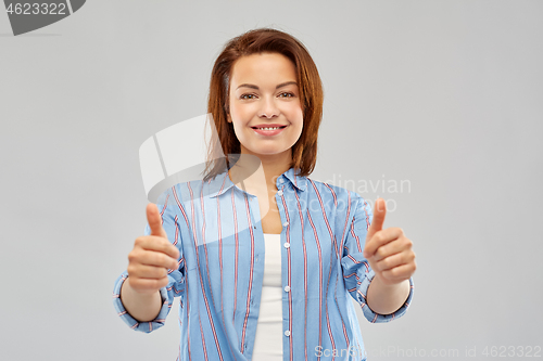 Image of smiling woman in shirt showing thumbs up