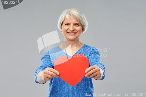 Image of smiling senior woman with red heart