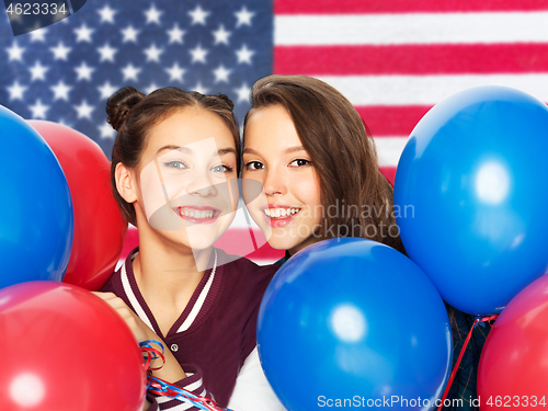 Image of teenage girls with balloons over american flag