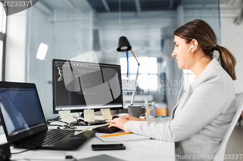 Image of businesswoman with computer working at office