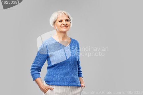 Image of portrait of smiling senior woman in blue sweater