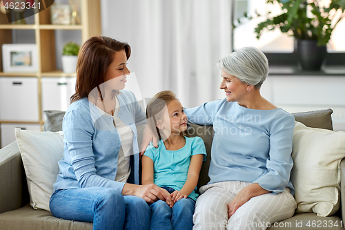 Image of smiling mother, daughter and grandmother