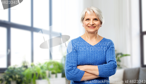 Image of smiling senior woman in blue sweater at home