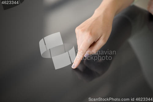 Image of hand using black interactive panel