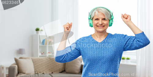 Image of senior woman in headphones listening to music