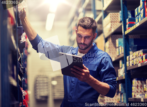 Image of auto mechanic or smith with tablet pc at workshop