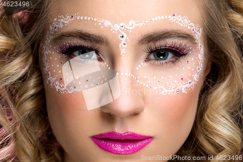 Image of Girl with mask drawn on face