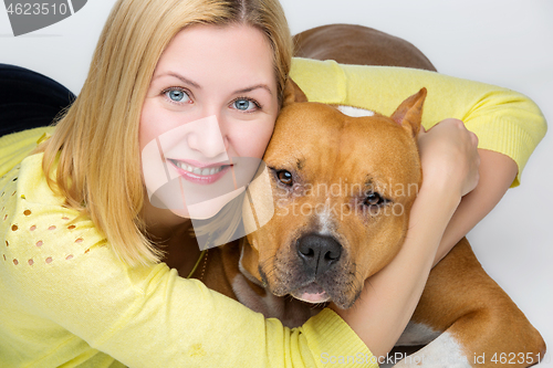 Image of Girl with amstaff dog