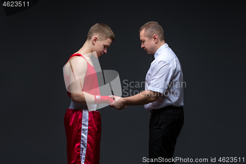 Image of Referee checking young boxer
