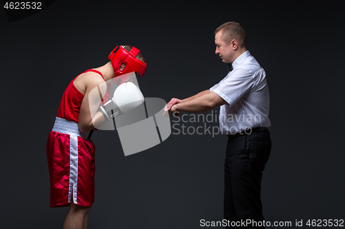 Image of Referee checking young boxer