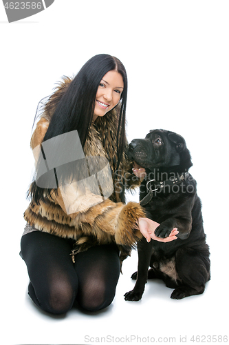 Image of Girl with black shar pei dog