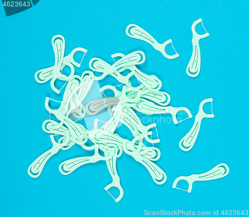 Image of Floss toothpicks isolated on blue background