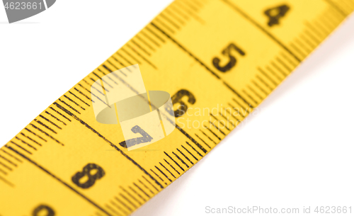 Image of Close-up of a yellow measuring tape isolated on white - 7