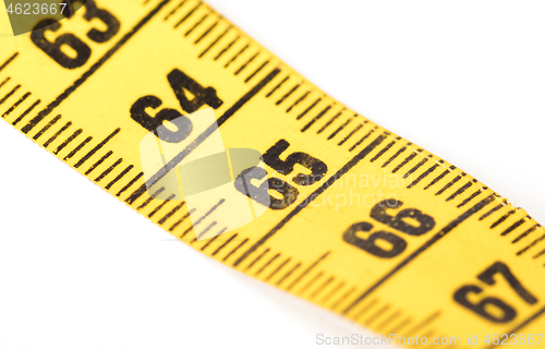 Image of Close-up of a yellow measuring tape isolated on white - 65