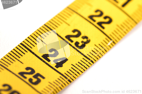 Image of Close-up of a yellow measuring tape isolated on white - 24