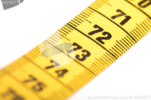 Image of Close-up of a yellow measuring tape isolated on white - 72