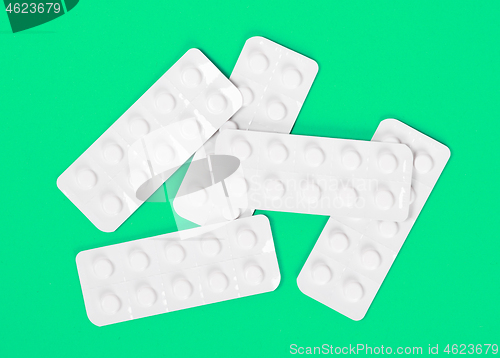 Image of Pill strips on green background