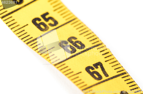 Image of Close-up of a yellow measuring tape isolated on white - 66