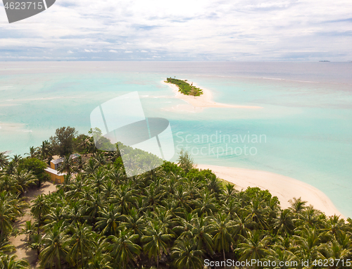 Image of Aerial drone view of picture perfect beach and turquoise lagoon on small tropical island on Maldives