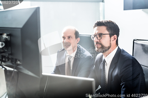 Image of Business team analyzing data at business meeting in modern corporate office.