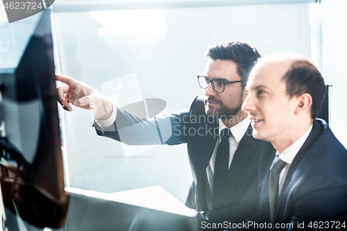 Image of Business team analyzing data at business meeting in modern corporate office.