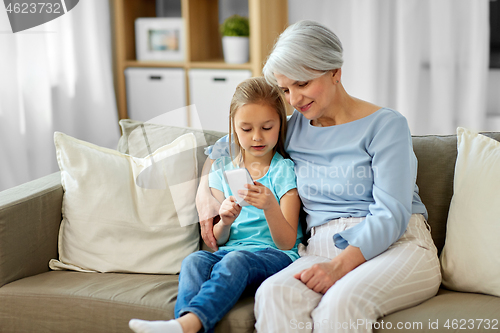 Image of grandmother and granddaughter with smartphone