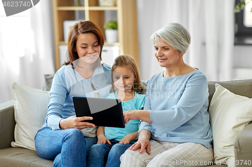 Image of mother, daughter and grandmother with tablet pc