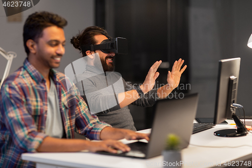 Image of creative man in virtual reality headset at office