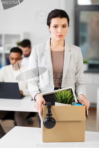 Image of female office worker with box of personal stuff