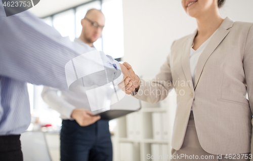 Image of close up of business people making handshake