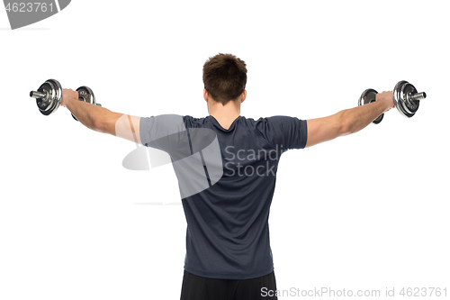 Image of young man with dumbbells exercising