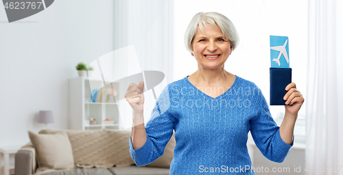 Image of senior woman with passport and airplane ticket