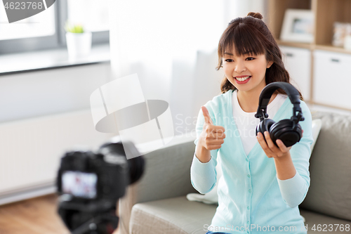 Image of female blogger with headphones making video blog