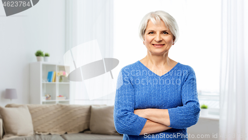 Image of smiling senior woman in blue sweater at home