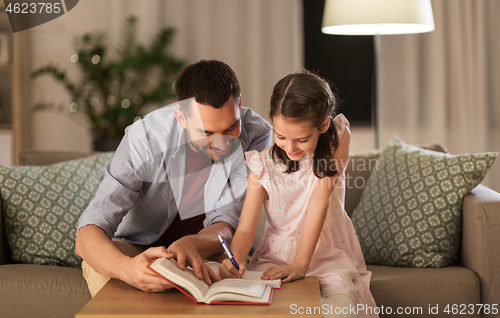 Image of father and daughter doing homework together