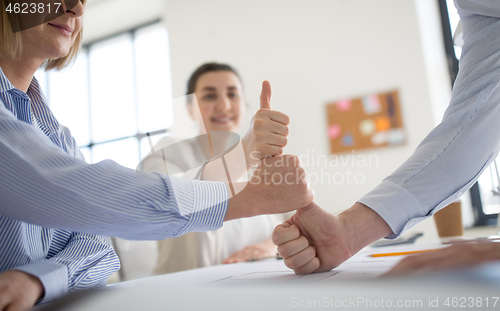 Image of group of business team making thumbs up gesture