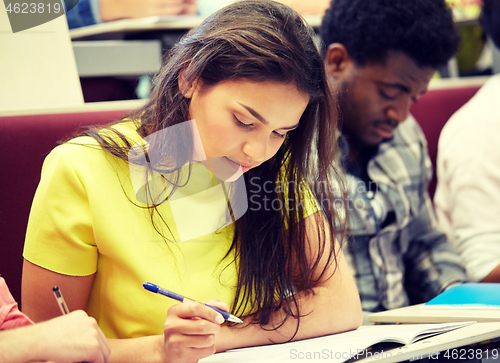 Image of group of international students writing at lecture