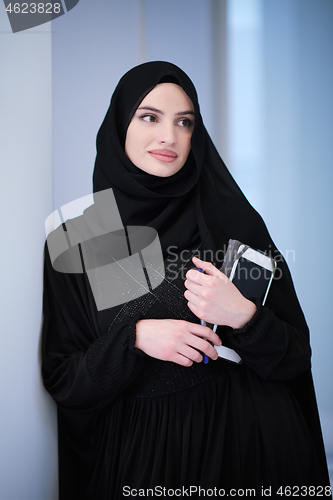 Image of muslim business woman using tablet computer