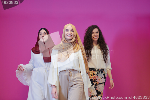 Image of muslim women in fashionable dress isolated on pink