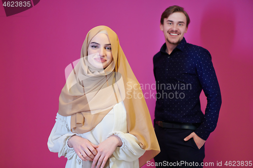 Image of portrait of young muslim couple isolated on pink background